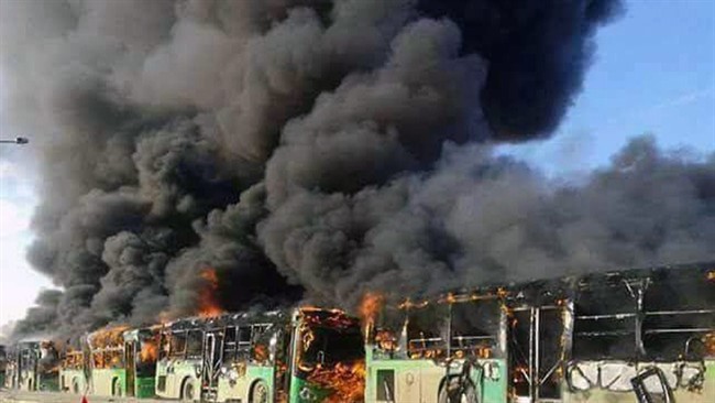 Smoke rises from government buses assigned to evacuate civilians in Idlib province, Syria, Dec. 18, 2016. The buses were allegedly burned by militants .