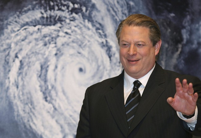 FILE - Former vice-president Al Gore in front of a poster of his documentary film "An Inconvenient Truth" on global warming.