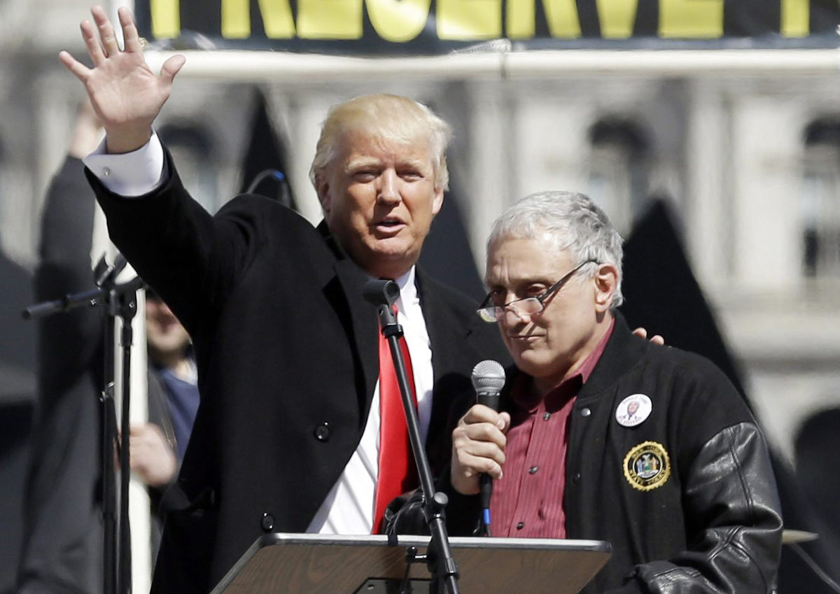  In this April 1, 2014, file photo, Donald Trump, left, is joined by Carl Paladino during a gun rights rally at the Empire State Plaza in Albany, N.Y. Paladino, who co-chaired president-Elect Donald Trump's state campaign, confirmed to The Associated Press on Friday, Dec. 23, 3016 that he told a New York alternative newspaper he hoped President Barack Obama would die from mad cow disease and that the first lady would "return to being a male." He now says those comments weren't enough to make Trump's transition team shun him.