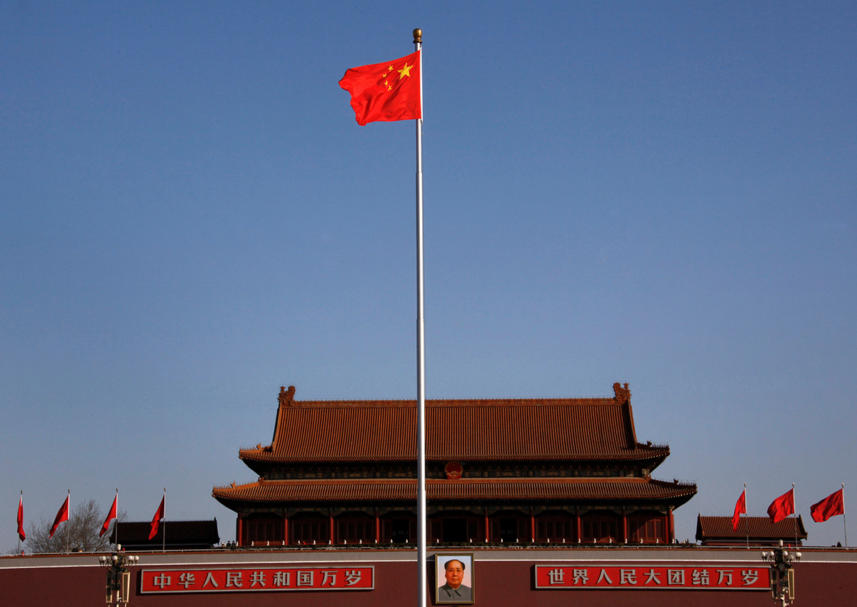 China's nation flag flies on Tiananmen Square in front of the portrait of the former chairman Mao Zedong ahead of the closing ceremony of the National People's Congress (NPC) at the Great Hall of the People in Beijing, March 14, 2012.