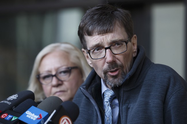 Bret McCann, flanked by his wife, Mary-Ann McCann, left, speaks to the media after giving a victim impact statement during the sentencing hearing for Travis Vader at the Edmonton Law Courts in Edmonton, Alta., on Monday, Dec. 12, 2016.