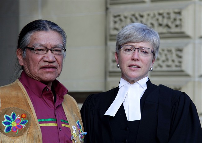 Edmund Metatawabin and lawyer Fay Brunning are seen outside court in Toronto on Wednesday, Dec. 14, 2016. Metatawabin and others who went to the notorious St. Anne's Indian residential school in Fort Albany, Ont., are fighting for compensation for the abuse they say they suffered. 