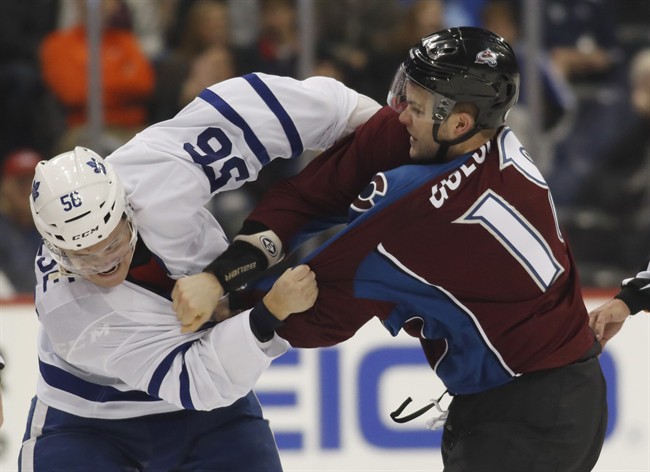 Byron Froese (left) fights with Colorado Avalanche defenceman Cody Goloubef during the third period of an NHL hockey game on Dec. 22, 2016, in Denver.