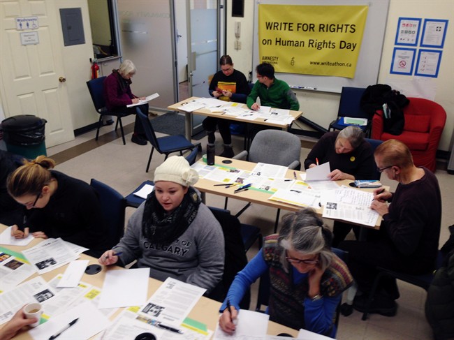 People take part in Amnesty International's Write for Rights campaign in Vancouver on Saturday, Dec. 10, 2016.
