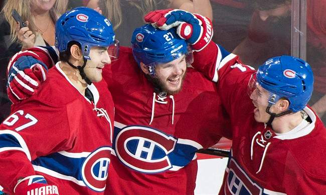 Montreal Canadiens' Alex Galchenyuk (27) celebrates with teammates Max Pacioretty (67) and Brendan Gallagher (11) after scoring against the Arizona Coyotes during second period NHL hockey action in Montreal on October 20, 2016.