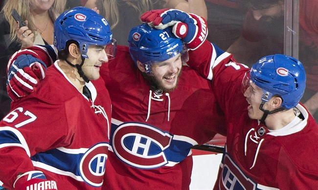 Montreal Canadiens' Alex Galchenyuk (27) celebrates with teammates Max Pacioretty (67) and Brendan Gallagher (11) after scoring against the Arizona Coyotes during second period NHL hockey action in Montreal on October 20, 2016.
