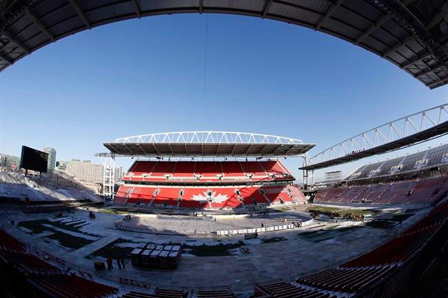 Workers install the rink at Toronto's BMO Field on Monday, December 19, 2016 as preparations continue for the NHL Centennial Classic between Toronto Maple Leafs and Detroit Red Wings on Jan.1. Tickets are still available to the NHL's Centennial Classic, the next in a long line of high-profile sports events in Toronto. THE CANADIAN PRESS/Chris Young.