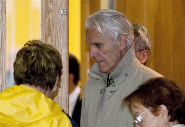 Former judge Jacques Delisle, centre, walks out of a courtroom at his murder trial Tuesday, May 8, 2012 in Quebec City.