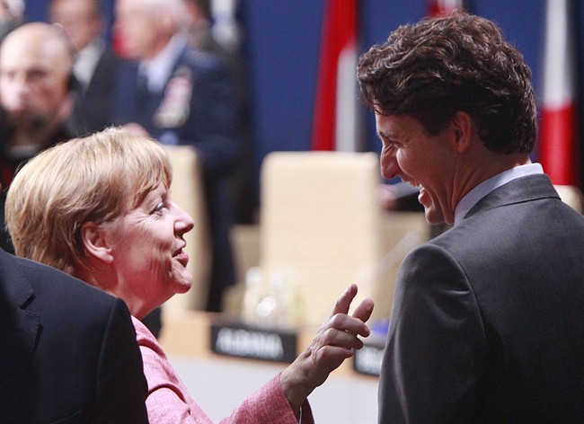 German Chancellor Angela Merkel,left, talks with Canadian Prime Minister Justin Trudeau prior to the meeting of the NATO-Ukraine Commission, during the second day of the NATO Summit in Warsaw, Poland, Saturday, July 9, 2016.