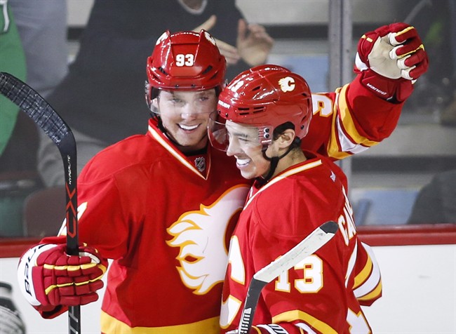 Calgary Flames' Sam Bennett, left, celebrates his goal with Johnny Gaudreau during second period NHL hockey action against the Winnipeg Jets in Calgary, Saturday, Dec.