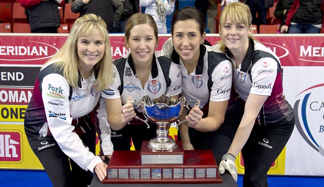 Team Jones skip Jennifer Jones, left to right, third Kaitlyn Lawes, second Jill Officer and lead Dawn McEwen pose with the trophy after defeating Team Homan at the Canada Cup of Curling final against Team Homan in Brandon, Man., on Sunday, Dec. 4, 2016. 