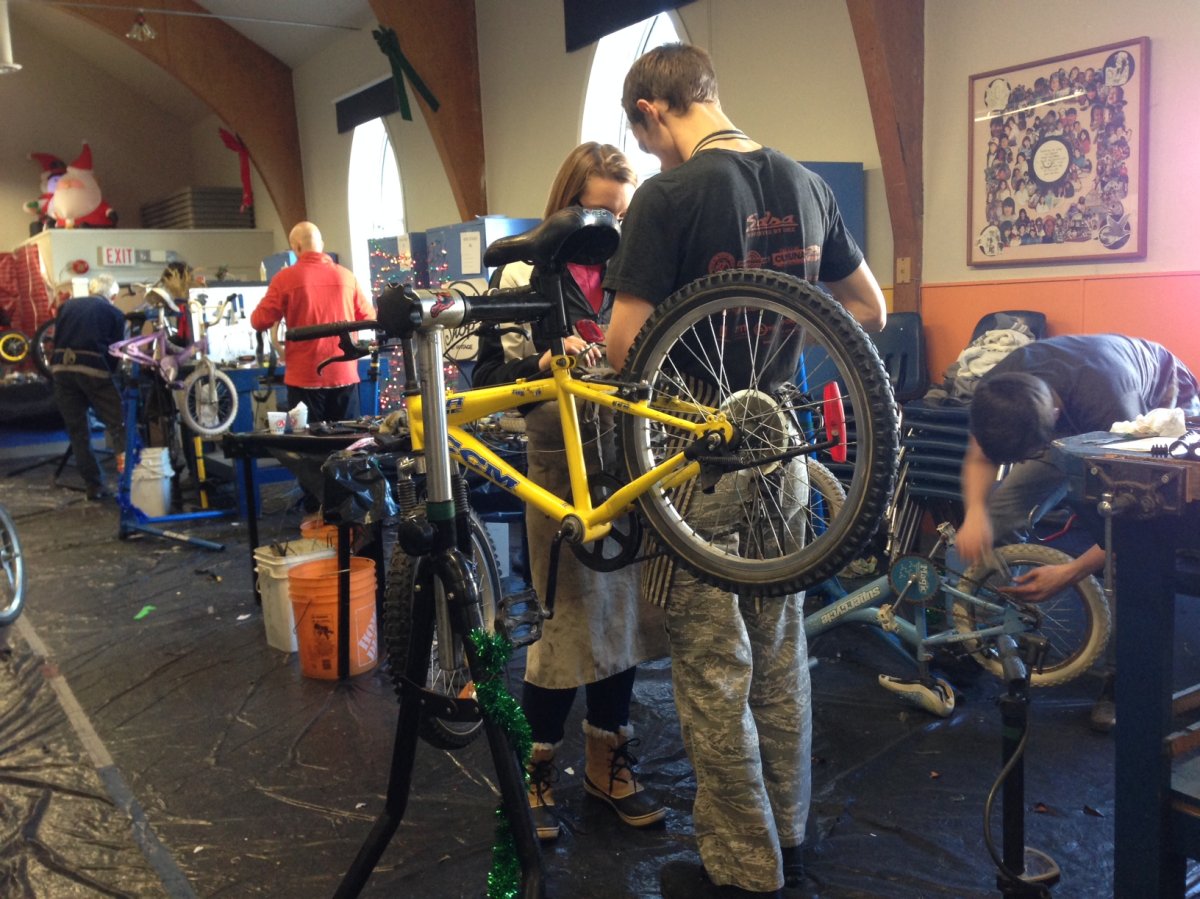 Volunteers make repairs to old bikes at Rossbrook House for kids in need.