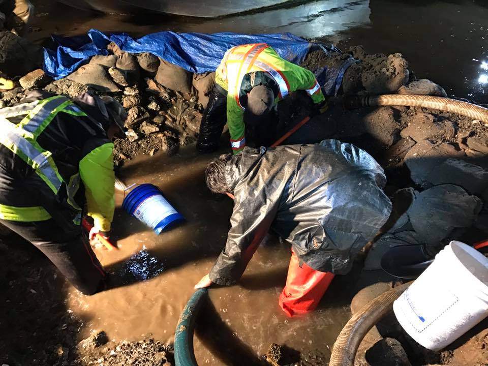 Members of the Ahousaht First Nation working to repair the damaged pipe.