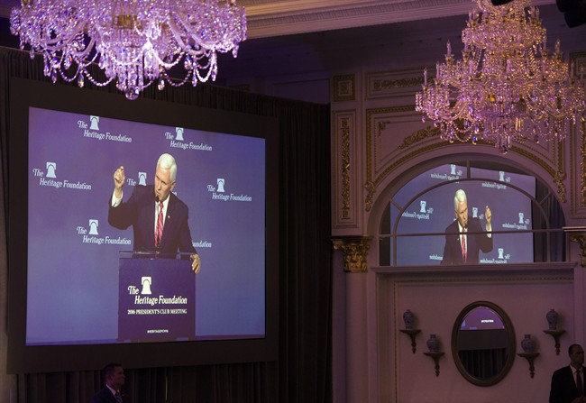 Vice President-elect Mike Pence is seen on a large video monitor, which is reflected in a mirror, in a ballroom at the Trump International Hotel as he addresses the Heritage Foundation's 2016 President's Club Meeting in Washington, Tuesday, Dec. 6, 2016.