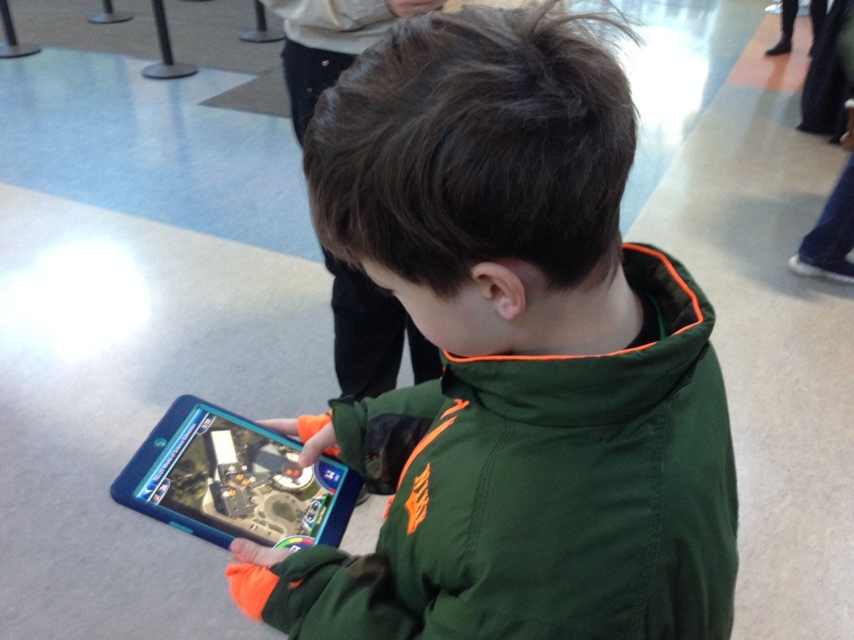 A boy plays a mobile game  released by an Alberta company that promises to be educational while helping kids get more active, Monday, Dec. 12, 2016. 