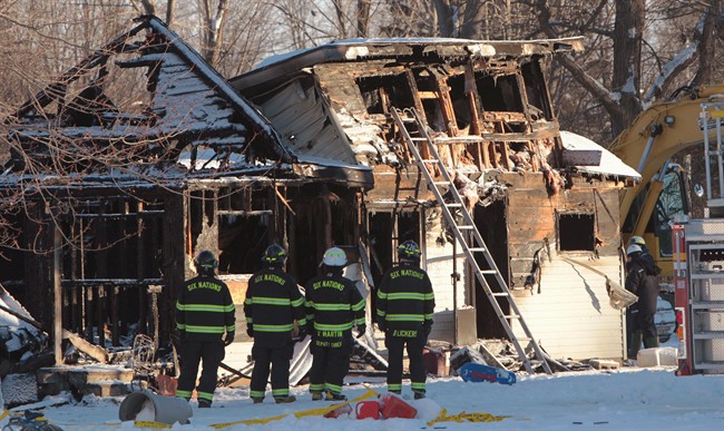 Fire fighters and Ontario Fire Marshall officials attend the scene of a house fire on Oneida Nation of the Thames, southwest of London, Ont., Thursday Dec. 15, 2016.