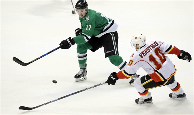Calgary Flames right wing Kris Versteeg (10) and Dallas Stars center Devin Shore (17) skate for the puck during the second period of an NHL hockey game in Dallas, Tuesday, Dec. 6, 2016. 