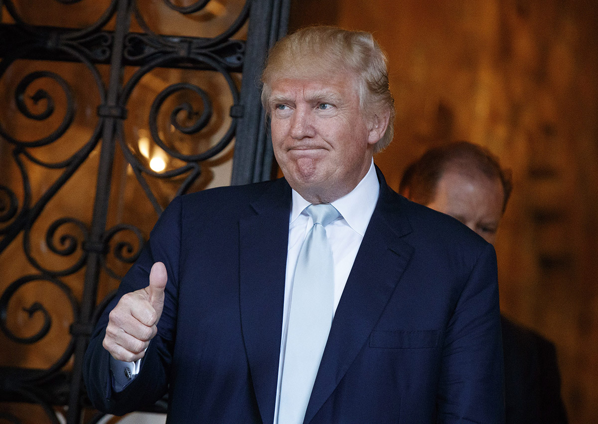 President-elect Donald Trump gives a thumbs up to reporters at Mar-a-Lago, Wednesday, Dec. 28, 2016, in Palm Beach, Fla. 
