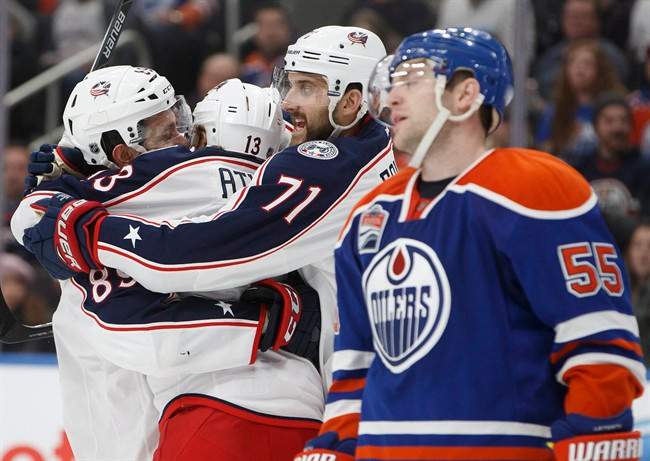 Columbus Blue Jackets' Sam Gagner (89), Cam Atkinson (13) and Nick Foligno (71) celebrate goal as Edmonton Oilers' Mark Letestu (55) skates past during third period NHL action in Edmonton, Alta., on Tuesday December 13, 2016. 