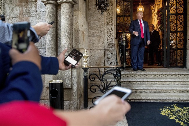 President-elect Donald Trump, right, speaks to members of the media after a meeting with admirals and generals from the Pentagon at Mar-a-Lago, in Palm Beach, Fla., Wednesday, Dec. 21, 2016.
