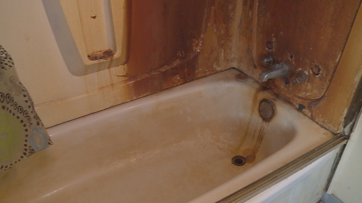 Discolouration is pictured on the walls and faucet of Marlene Brown's bathtub. She says the erosion shows the impact of high levels of contaminants in her drinking water.