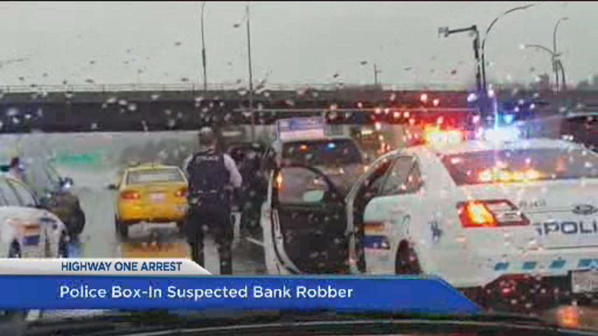 Police arrest a man along Highway 1 in Coquitlam.