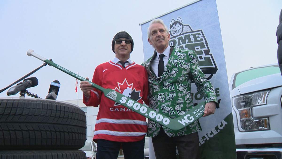 Vaughn Wyant presents U of S president Peter Stoicheff with $500,000 donation to Home Ice Campaign.