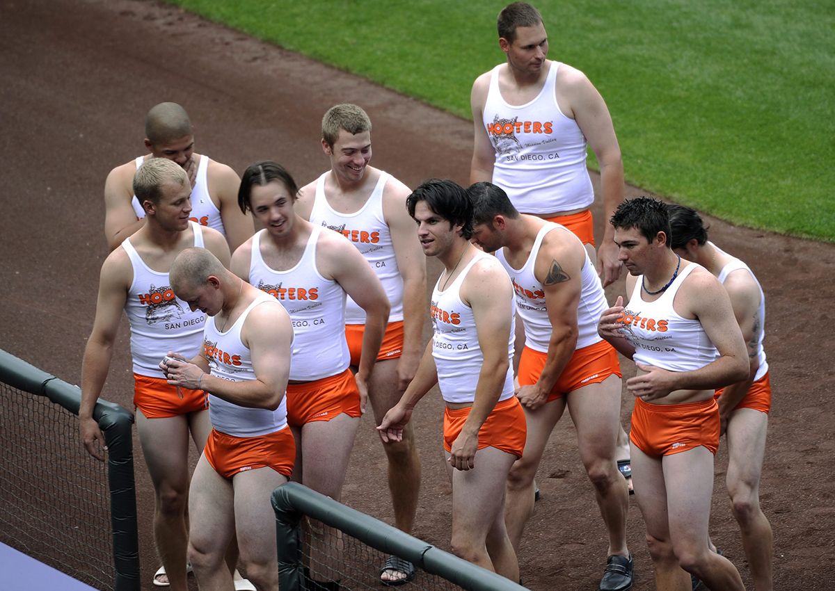 In this Sept. 17, 2008, file photo, rookie members of the San Diego Padres baseball team are dressed like waitpeople at a Hooter's restaurant, as part of rookie hazing after the Padres' 1-0 loss to the Colorado Rockies in a baseball game at Coors Field in Denver. 