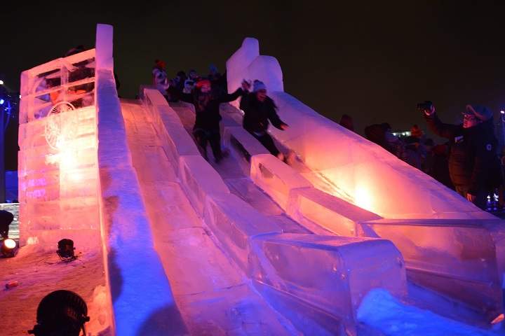 In this file photo, girls slide down ice toboggans, during the second Igloofest week-end in the Old Port, on January 24, 2015.