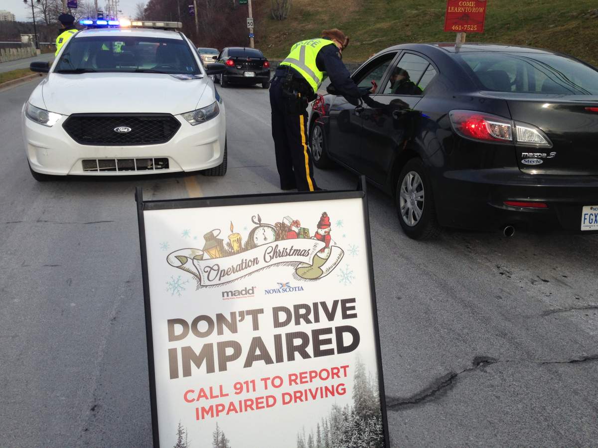 A police officer speaks with a driver at a police checkpoint in Cole Harbour on Wednesday, Dec. 7, 2016.