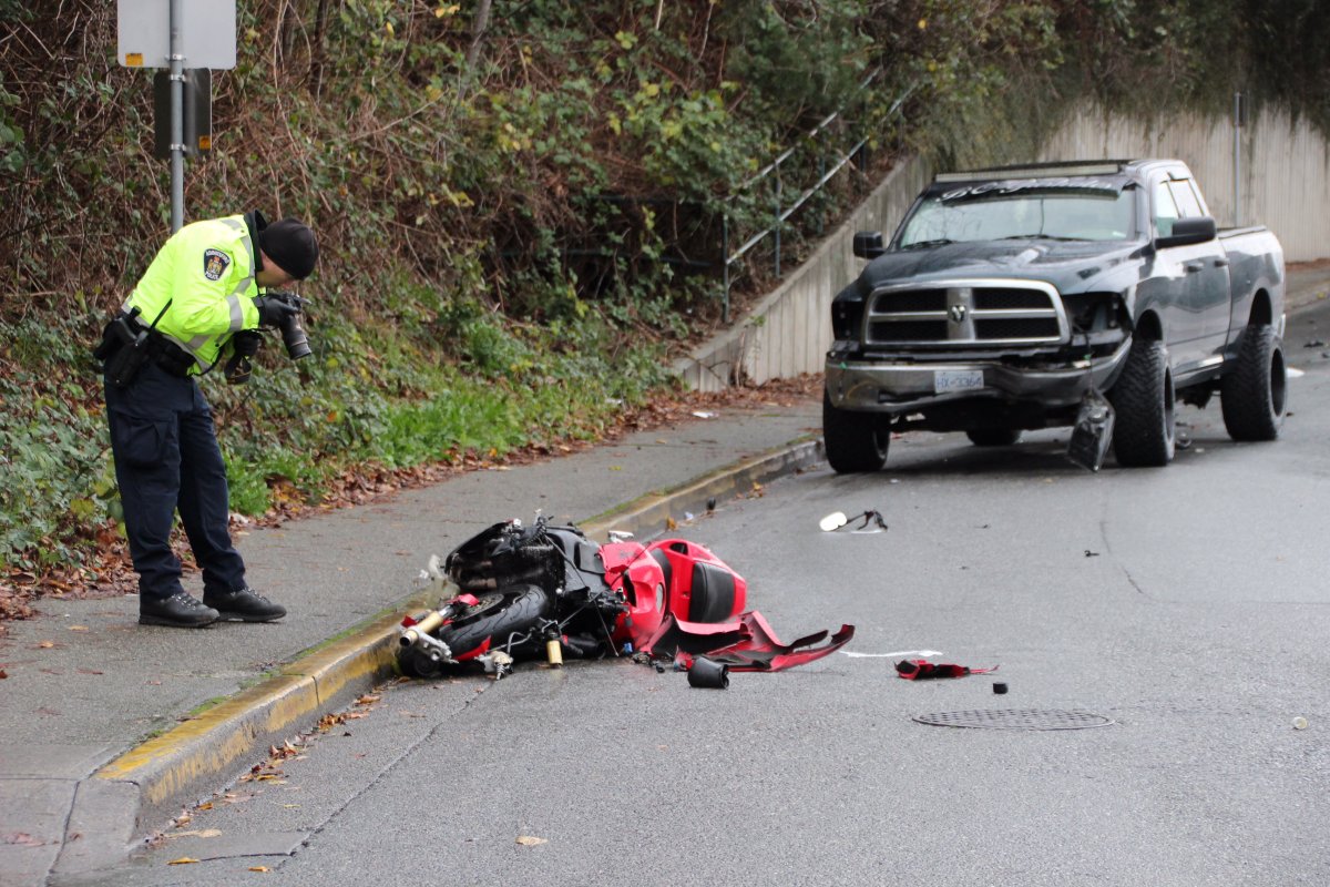 A police officer at the scene of a fatal collision involving a motorcycle and a pickup truck near Old Yale Road and Essendene Avenue in Abbotsford on Saturday, Dec. 3, 2016.