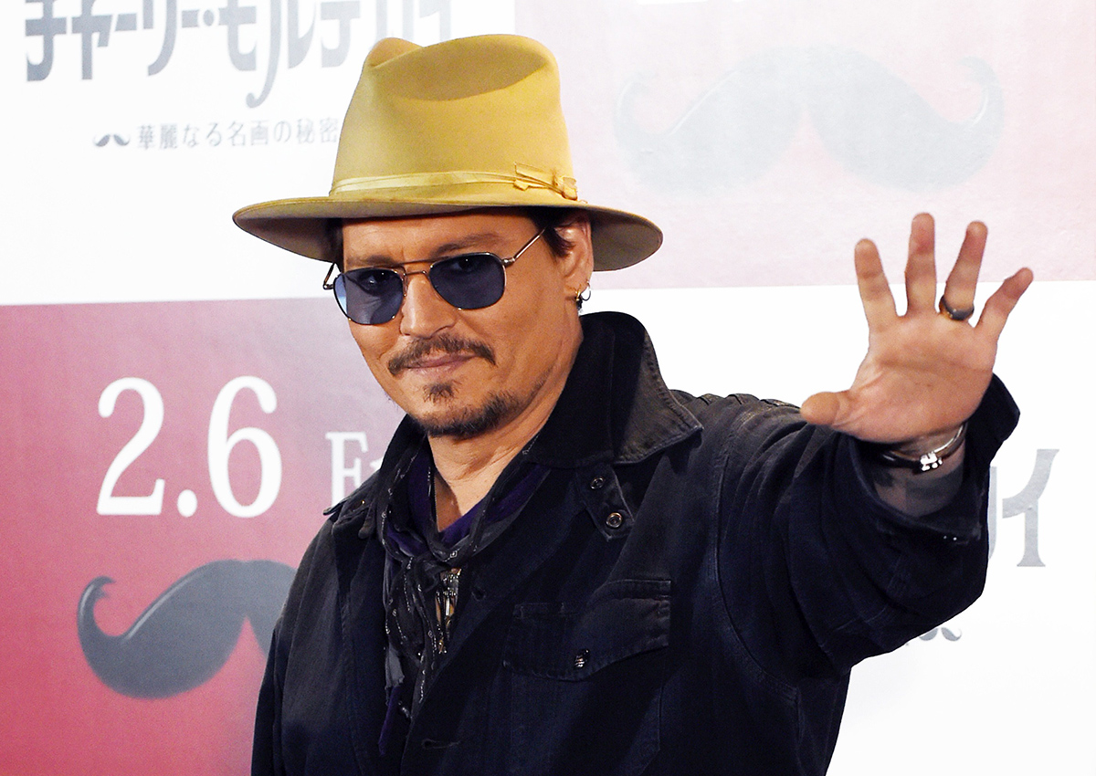 Johnny Depp waves during his photo call in Tokyo on January 28 2015.