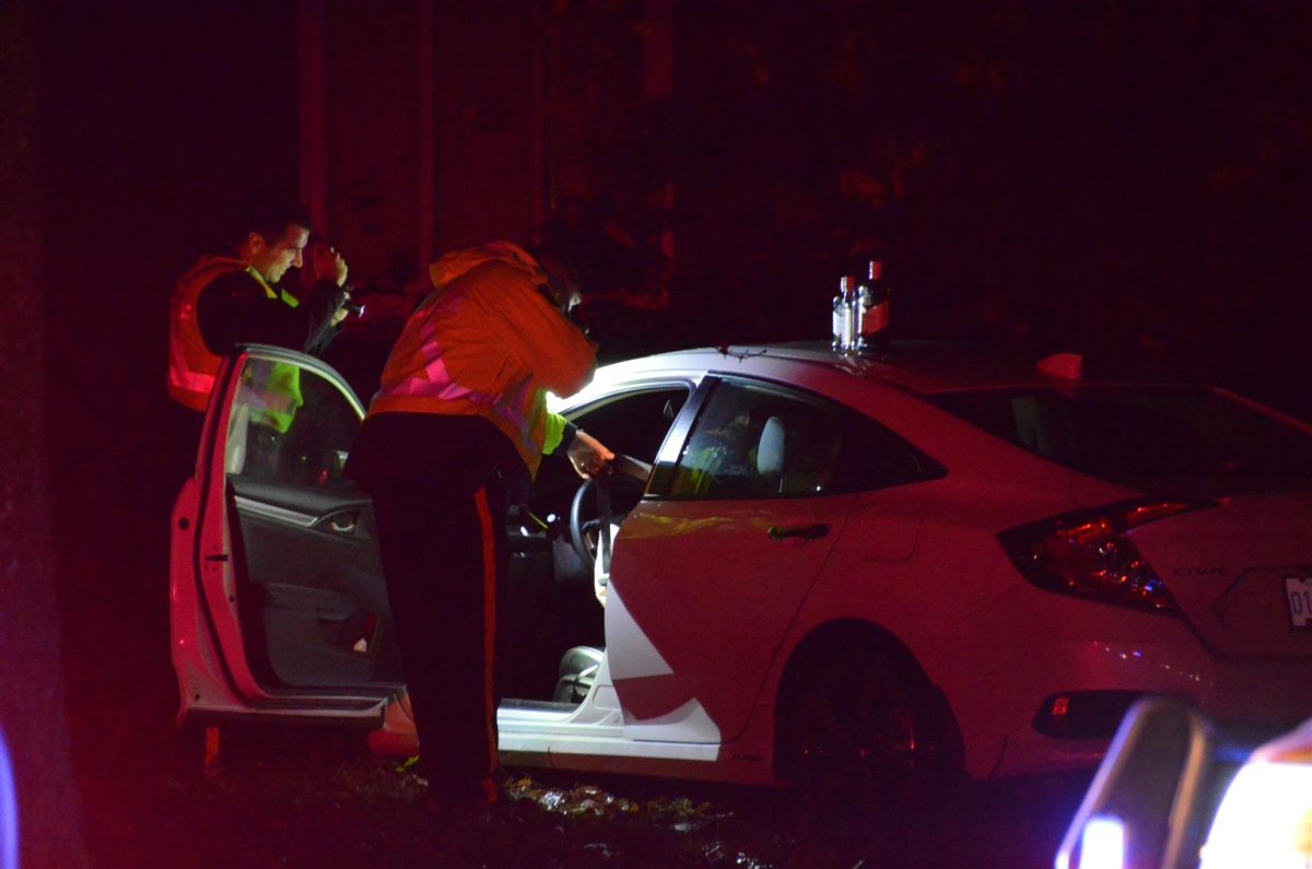 Police looking in the car after the crash in Langley.