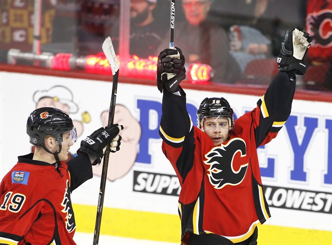Calgary Flames' Matt Stajan, right, celebrates his goal with Matthew Tkachuk against the Anaheim Ducks during second period NHL action in Calgary, Alta., Sunday, Dec. 4, 2016. 