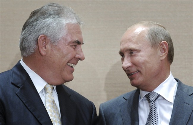 In this Aug. 30, 2011, file photo, Russian Prime Minister Vladimir Putin, right, and Rex Tillerson, former ExxonMobil CEO smile during a signing ceremony in the Black Sea resort of Sochi, Russia.