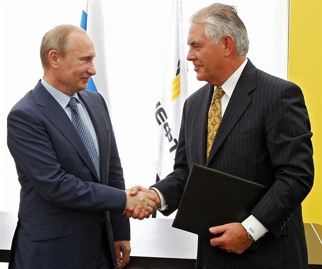 In this June 15, 2012, file photo, Russian President Vladimir Putin, left, and ExxonMobil CEO Rex Tillerson shake hands at a signing ceremony of an agreement between state-controlled Russian oil company Rosneft and ExxonMobil at the Black Sea port of Tuapse, in southern Russia.
