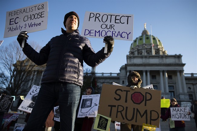 Protesters demonstrate ahead of Pennsylvania's 58th Electoral College at the state Capitol in Harrisburg, Pa., Monday, Dec. 19, 2016.