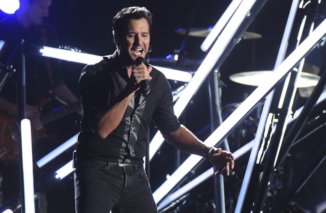 FILE - In this Nov. 2, 2016, file photo, Luke Bryan performs "Move" at the 50th annual CMA Awards at the Bridgestone Arena in Nashville, Tenn. 