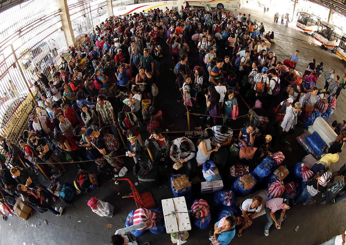 Filipinos board buses before Christmas Day at a bus terminal in Pasay city, south of Manila. 