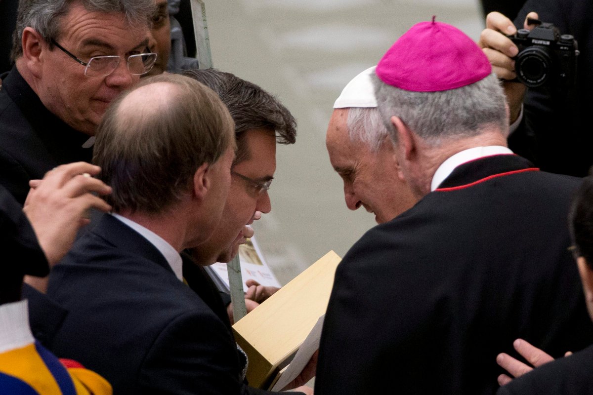 Pope Francis, second right, shares a word with Montreal mayor Denis Coderre, third right, during his weekly general audience in the Pope Paul VI hall, at the Vatican, Wednesday, Feb. 4, 2015. 