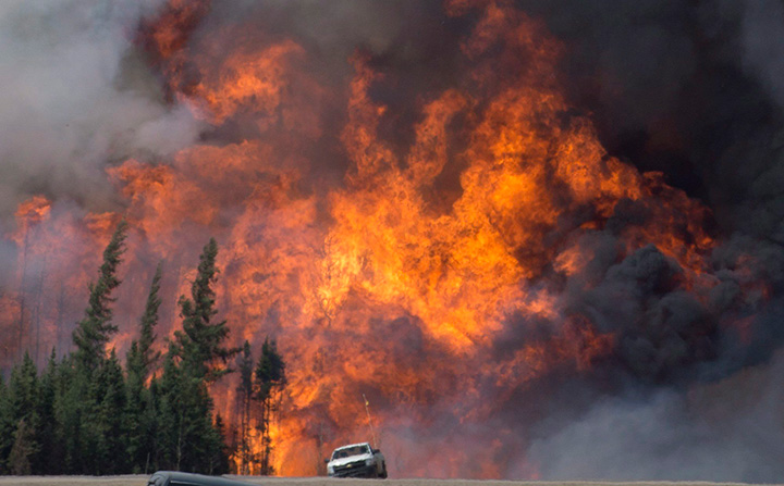 A giant fireball is seen as a wildfire rips through the forest just south of Fort McMurray, Alberta on May 7, 2016.