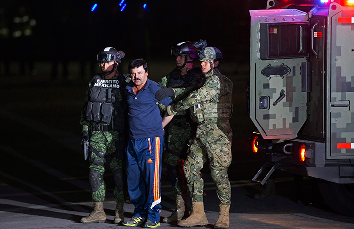 Mexican army soldiers escort drug lord Joaquin “El Chapo” Guzman to a helicopter to be transported to a maximum security prison in Mexico City on Jan. 8, 2016.
