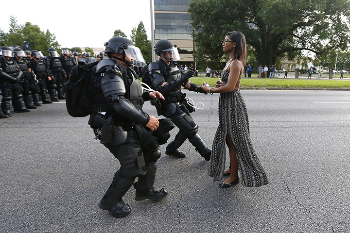 A demonstrator protesting the shooting death of Alton Sterling is detained by law enforcement near the headquarters of the Baton Rouge Police Department in Louisiana on July 9, 2016.