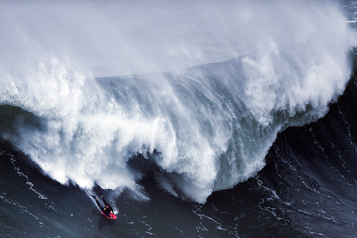 A bodyboarder rides a wave during a surfing session at Praia do Norte in Nazare, Portugal on Nov. 19, 2016.