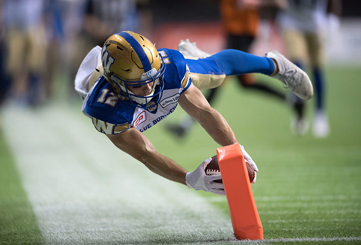 Ryan Smith dives for the goal line to score his second touchdown against the B.C. Lions during the CFL Western Semifinal in Vancouver, B.C. on Nov. 13, 2016.