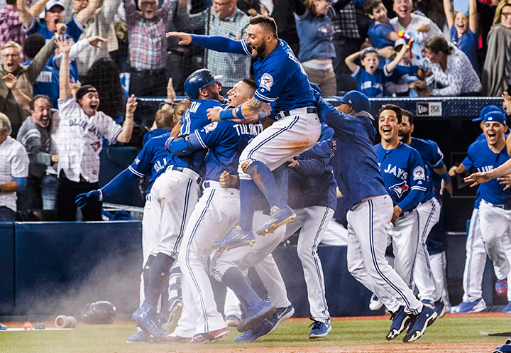 Toronto Blue Jays celebrate their walk-off win to eliminate the Texas Rangers during the 10th inning of the American League Division Series in Toronto on Oct. 9, 2016.