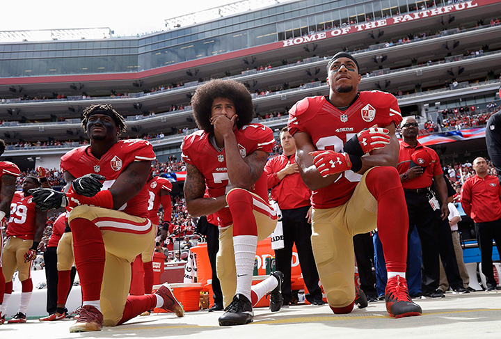 San Francisco 49ers outside linebacker Eli Harold, left, quarterback Colin Kaepernick, centre, and safety Eric Reid kneel during the national anthem before a game against the Dallas Cowboys in Santa Clara, Calif., on Oct. 2, 2016.