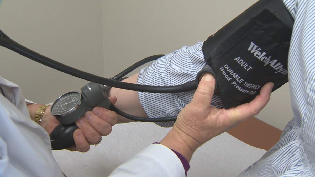 Doctor checks blood pressure