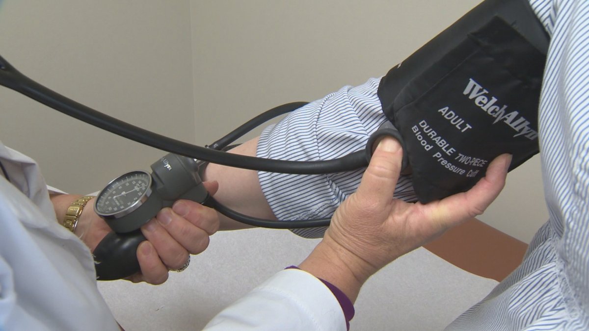 Doctor checks blood pressure