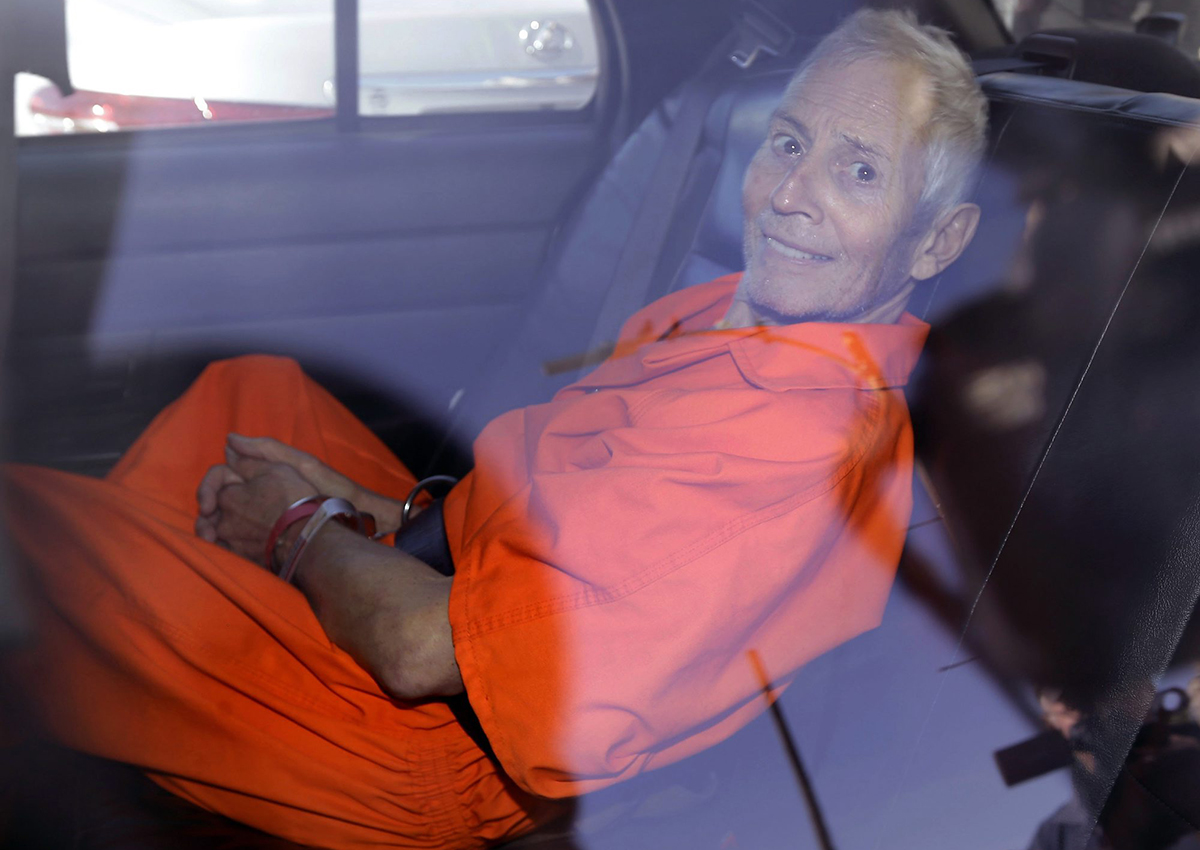 In March 17, 2015, file photo, New York real estate heir Robert Durst smiles as he is transported from Orleans Parish Criminal District Court to the Orleans Parish Prison after his arraignment on murder charges in New Orleans. 